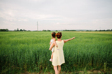 mom and daughter in the field. summertime.