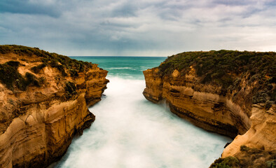 Waves crashing around cliff