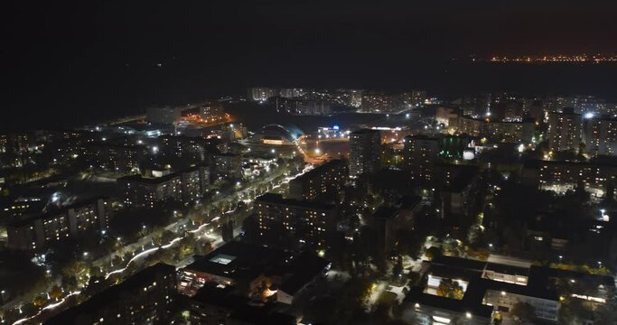 Big city from above night timelapse. Aerial view of the city center and residential districts. Wide avenue traffic. 