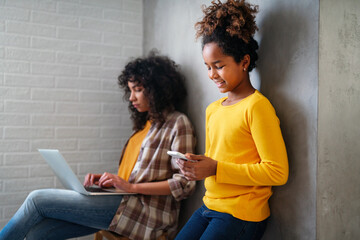 Black ethnicity student girls,sisters using a laptop computer for online courses