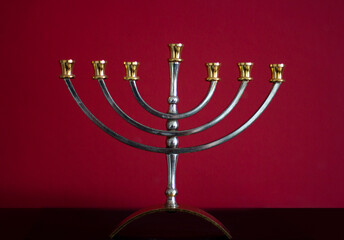 Fototapeta na wymiar Traditional candelabrum menorah on red background, Jewish symbol
