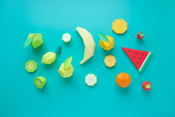 Different exotic fruits made of paper on trendy mint background