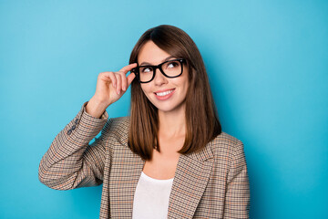 Portrait of nice optimistic brunette lady look empty space wear spectacles blazer isolated on vivid blue color background