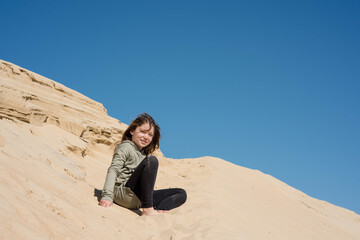 cute little girl playing in the sand dunes