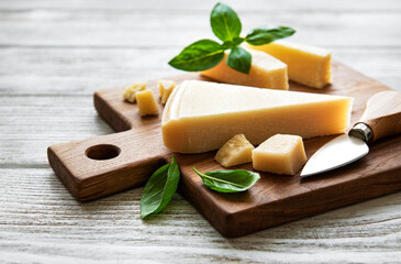 Piece of parmesan cheese on a wooden board