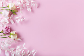 Frame of white branches on a pink background