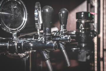 Silver beer taps close-up. Pouring column for beer. Row of Beer Taps in Pub.