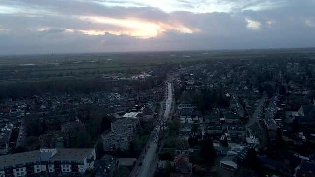 Aerial of calm street in small Dutch town at sunrise