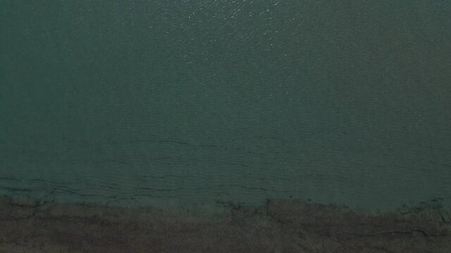 4k overhead  moving forward clip over a peninsula on  the tropical beach of Epanomi, Halkidiki, Greece