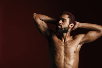 Black shirtless sportsman posing with hands behind his head