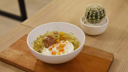 Spicy korean noodle with egg served on the table.