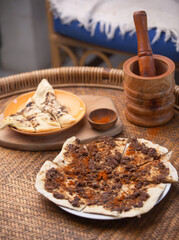 Manakish Lahm Bi Ajeen - Flatbreads topped with minced lamb or beef and Fatayer stuffed pie with spinach. Traditional Arab delicious food