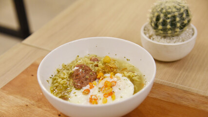 Spicy korean noodle with egg served on the table.