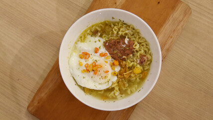 Spicy korean noodle with egg served on the table.