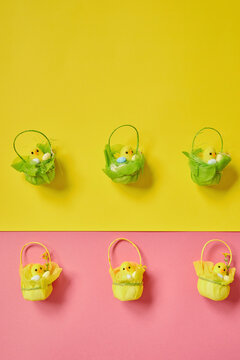 Easter eggs on the yellow -pink background. Happy Easter. Holiday concept. Focus on chicken on yellow background.