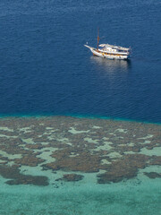 White boat in beautiful blue and turquoise sea in Gili Lawa Darat island bay, Komodo National Park, Flores, East Nusa Tenggara, Indonesia © Cyril Redor