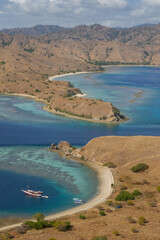 Colorful landscape view of the narrow strait between Gili Lawa Darat island and Komodo island in the background, Flores, East Nusa Tenggara, Indonesia © Cyril Redor
