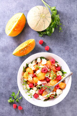 melon salad with mozzarella,  ham and raspberry