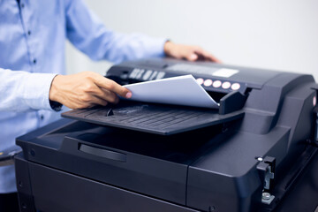 Bussiness man Hand press button on panel of printer, printer scanner laser in office copy machine...