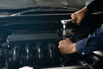 Car service, repair, maintenance concept. Auto mechanic working in garage.