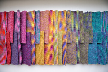 A set of tissue samples with different textures and colors. Multicolored fabric stripes in the interior catalog of upholstered furniture and other textiles.