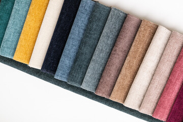 A set of tissue samples with different textures and colors. Multicolored fabric stripes in the interior catalog of upholstered furniture and other textiles.