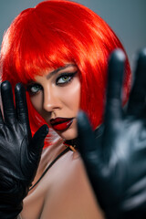 Fashion Portrait Woman, red hair. Makeup - Red Lips. Fashion model girl posing on gray background studio.  