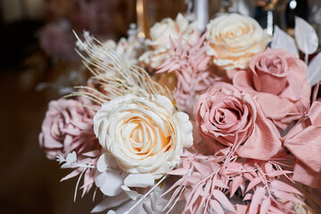 Bouquets artificial fabric roses close up at home interior. Wedding or celebration decoration concept