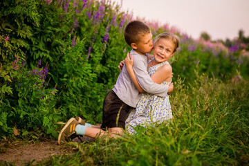 Fototapeta premium happy children in light clothes on the path in the park, a summer concept and a happy free childhood