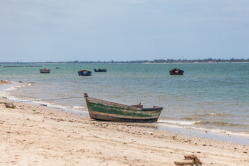 Fototapeta na wymiar View of traditional fishing boats floating on the edge of the Luanda bay beach, Mussulo island as background