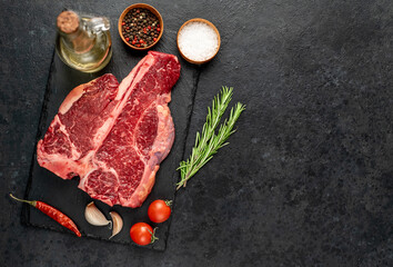 raw T-Bone Beef Steak on stone background with copy space for your text