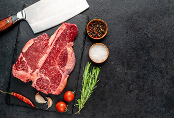 raw T-Bone Beef Steak on stone background with copy space for your text