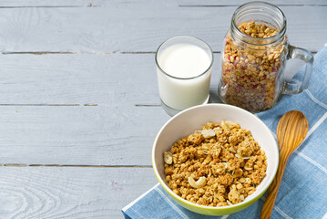 Yogurt with granola and fresh blueberries and raspberry, in glass. Healthy breakfast: yogurt parfait with granola and berries