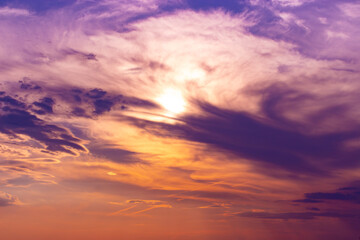 Naklejka na ściany i meble Orange lilac sunset sky with feather clouds. Backdrop background for design