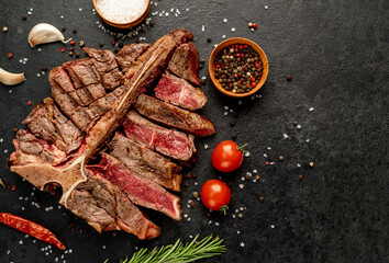 Grilled T-Bone Beef Steak on a stone background with copy space for your text