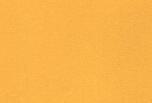Yellow coloured creative uncoated paper background. Extra large highly detailed image.