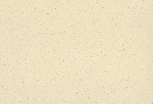Recycled beige, light yellow paper background with inclusions of small natural fibers. Extra large highly detailed image.