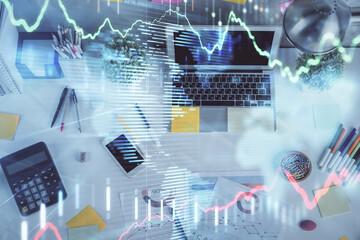 Double exposure of forex chart drawing over table background with computer. Concept of financial research and analysis. Top view.