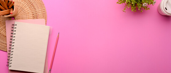 Pink flat lay workspace with stationery, plant pot, decoration and copy space