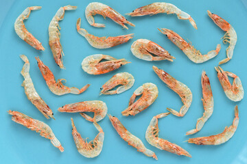 Dried sakura shrimp on light blue background.
