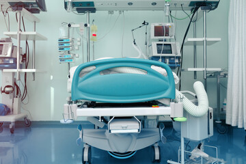 ICU bed surrounded by advanced artificial lung ventilation devices and other life support equipment