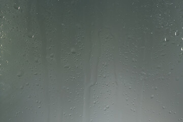 wet glass background condensate / abstract rain, drops texture on transparent glass