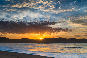 Fototapeta premium Sunrise seascape at the beach with haze and cloud