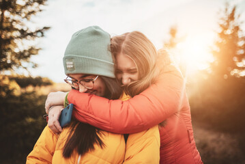 two girls embracing in nature
