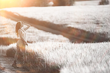 sexy girl in a t-shirt in a field / summer look, a beautiful young adult sexy model