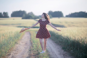 girl dress wheat field / happy summer vacation concept, one model in a sunny field