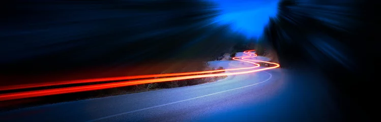Wall murals Highway at night Cars light trails at night in a curve mountains road, panorama