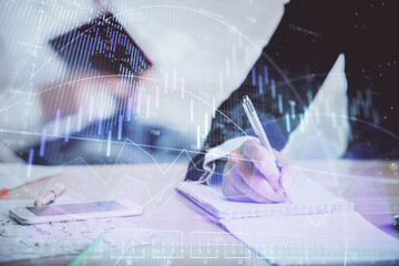 Double exposure of forex chart drawing over people taking notes background. Concept of financial analysis