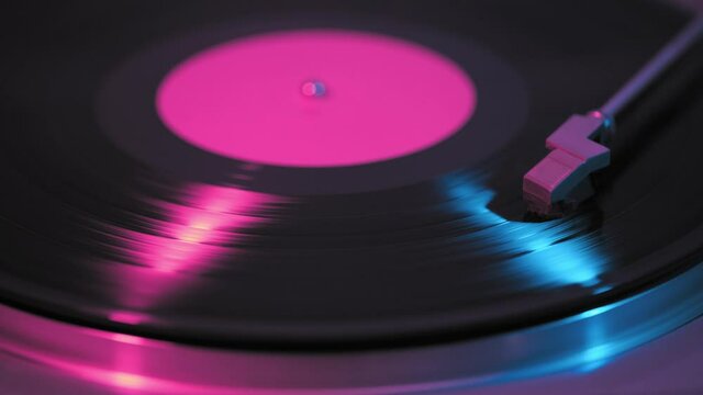 Old retro vinyl record, vintage turntable, neon light.