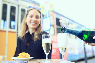 glasses of toast chin chin, hands with glasses of white wine in a street cafe